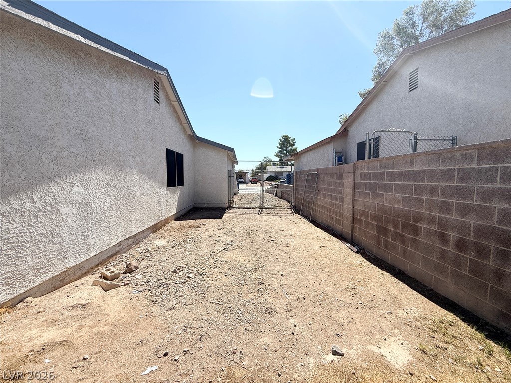 616 Greenway Road Henderson, NV 89002 - Photo 29 of 32 A spacious side yard offers potential for landscaping and outdoor enjoyment.