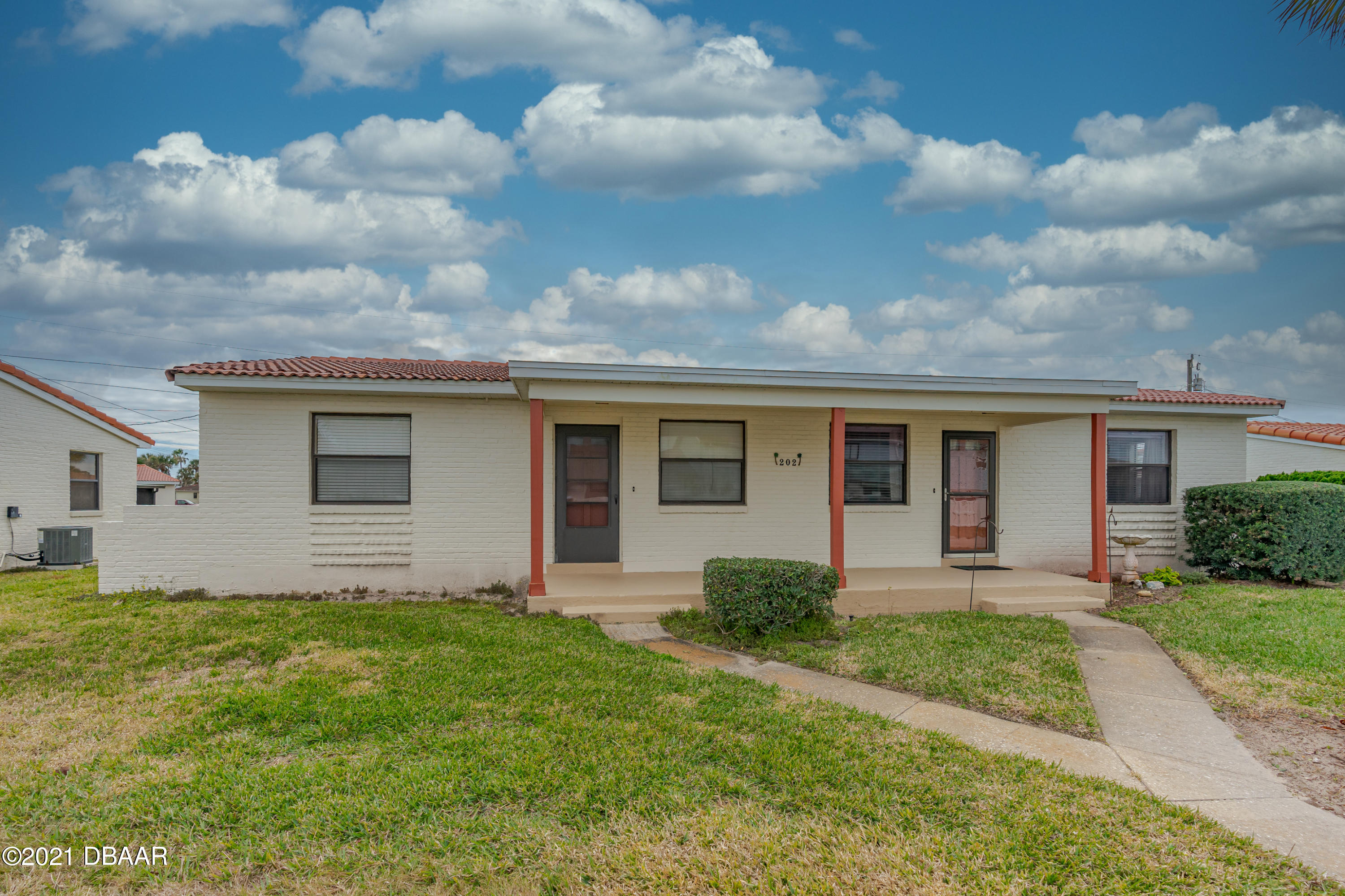 a front view of house with yard and green space