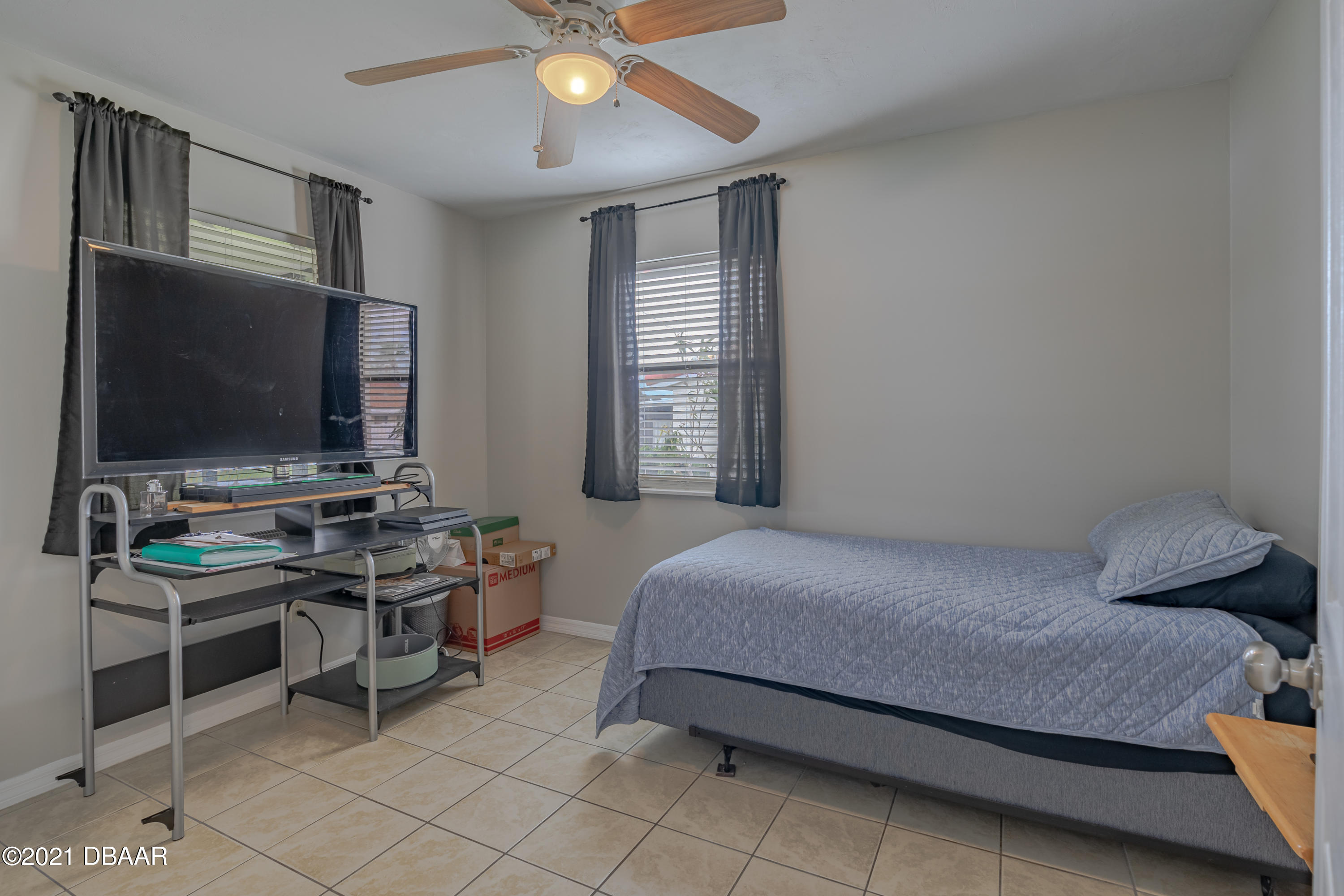 202 Northshore Drive, Unit B Ormond Beach, FL 32176 - Photo 12 of 25 a bedroom with a bed and a flat screen tv