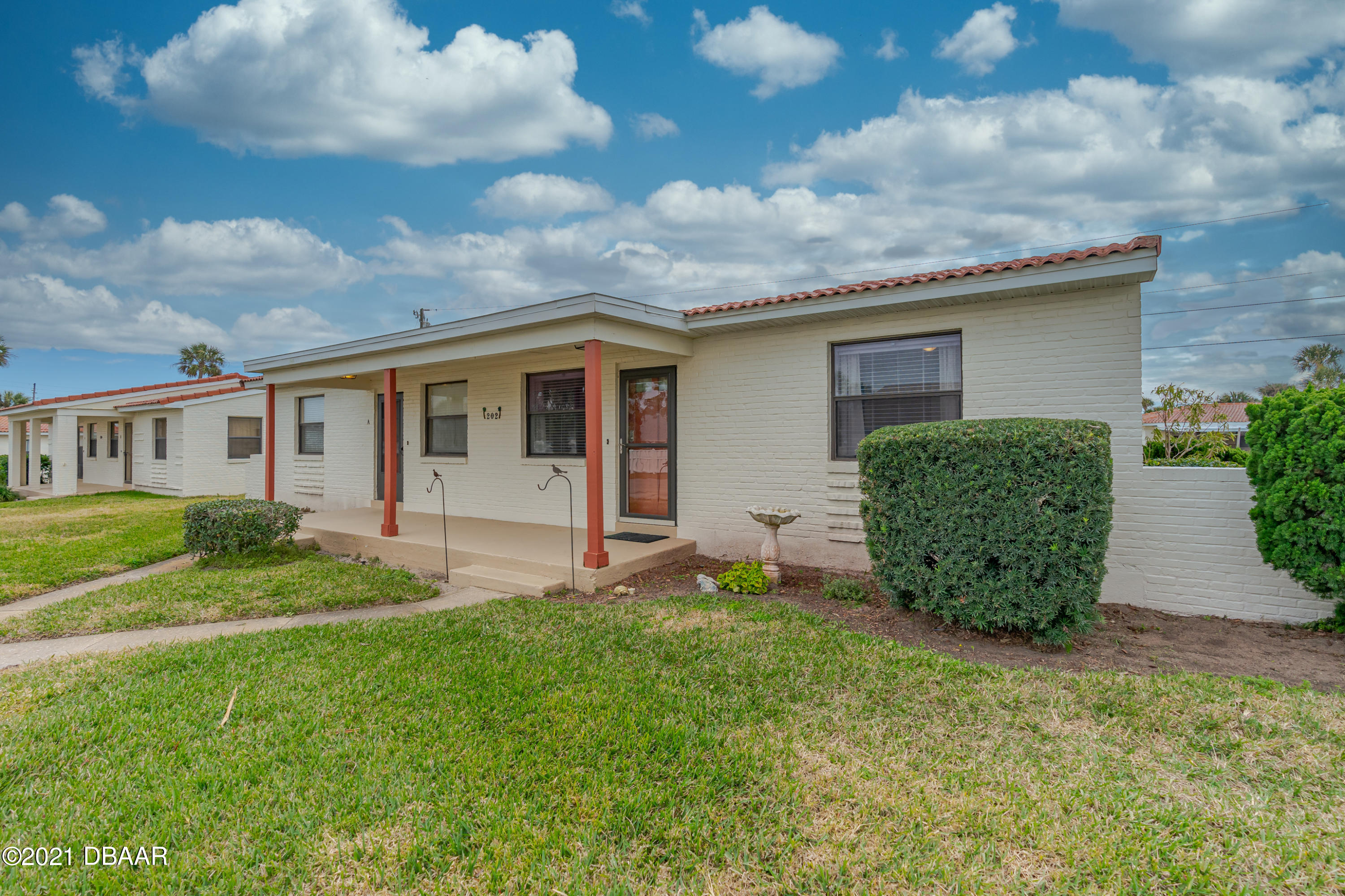 202 Northshore Drive, Unit B Ormond Beach, FL 32176 - Photo 2 of 25 a view of a house with backyard and garden