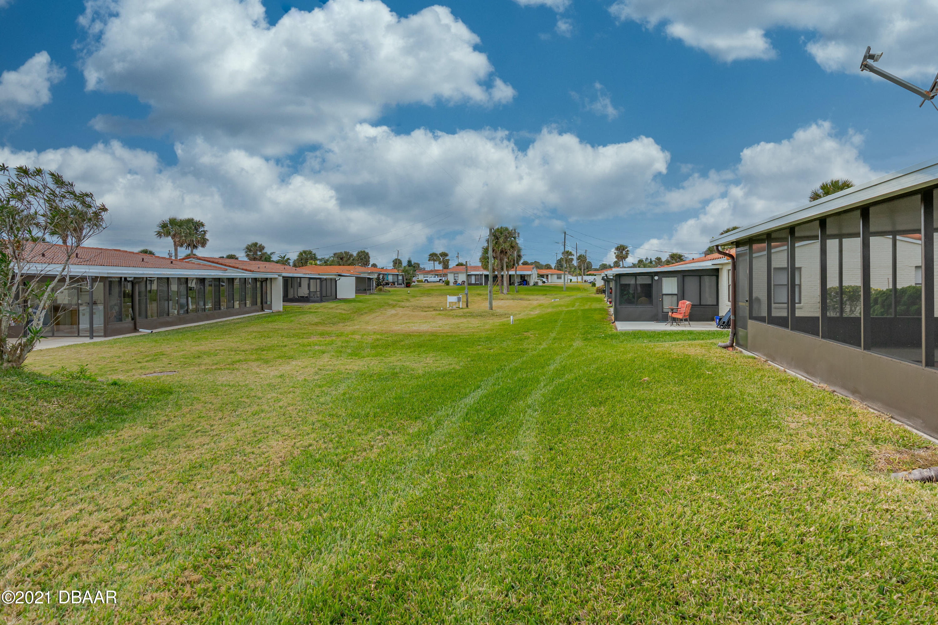 202 Northshore Drive, Unit B Ormond Beach, FL 32176 - Photo 4 of 25 a view of a swimming pool with a yard in front of it