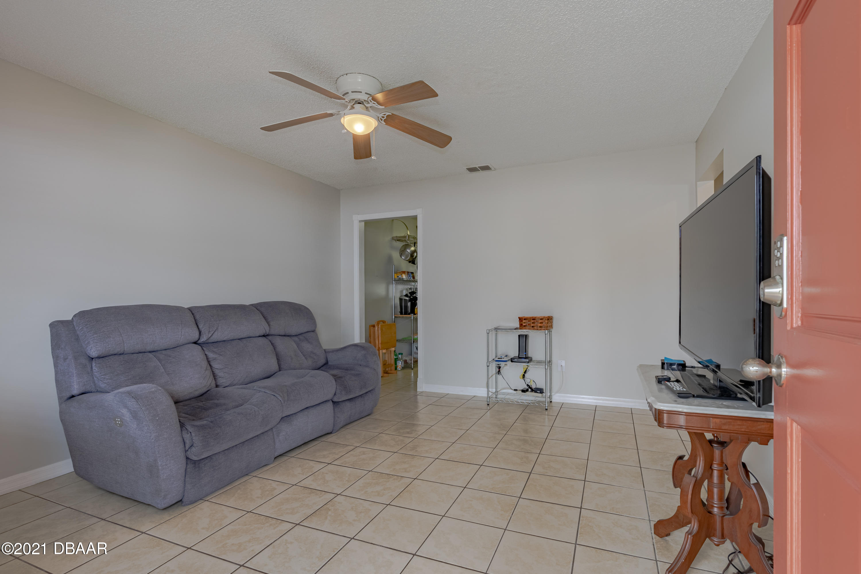 202 Northshore Drive, Unit B Ormond Beach, FL 32176 - Photo 7 of 25 a living room with furniture and a flat screen tv