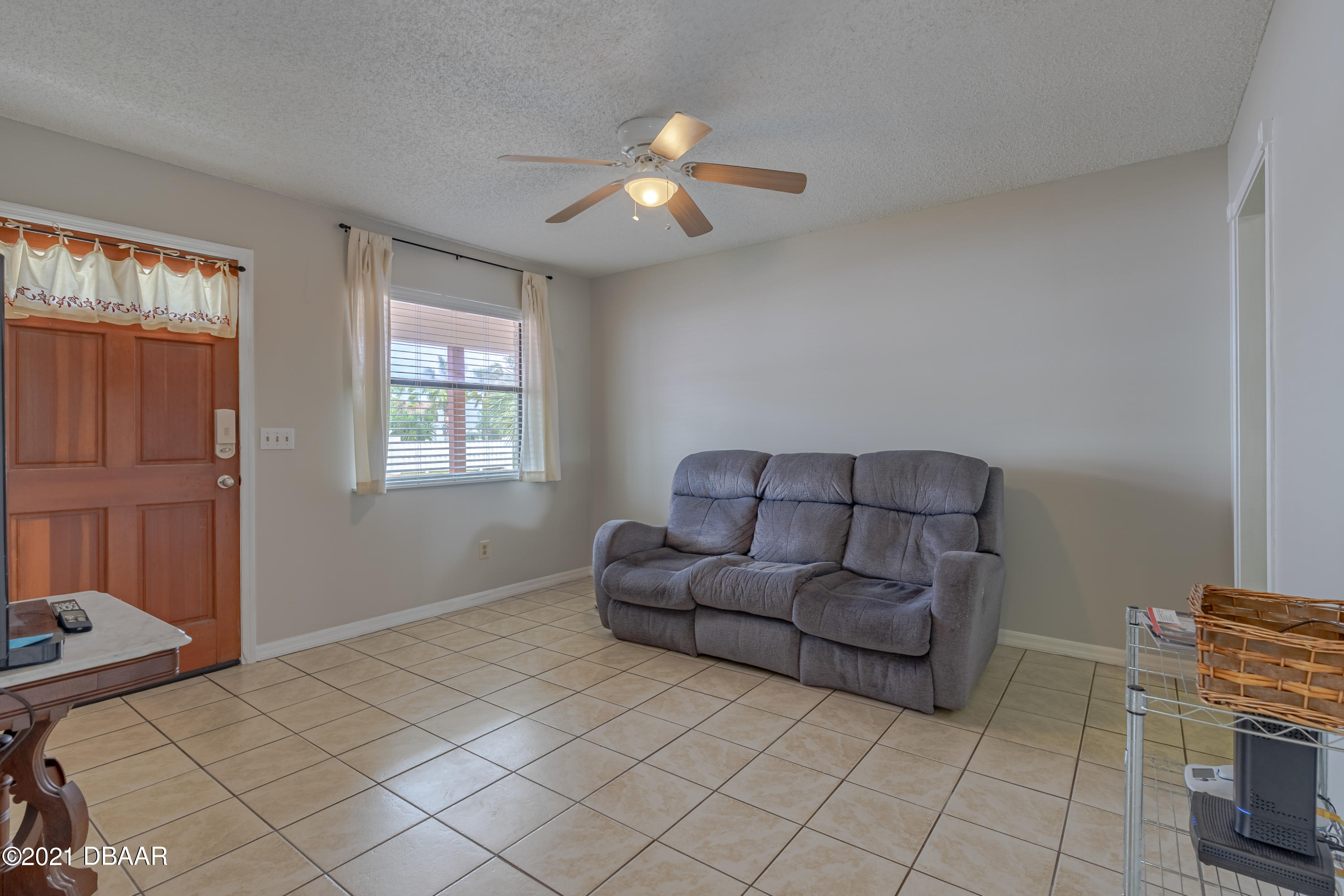 202 Northshore Drive, Unit B Ormond Beach, FL 32176 - Photo 8 of 25 a living room with furniture and a chandelier
