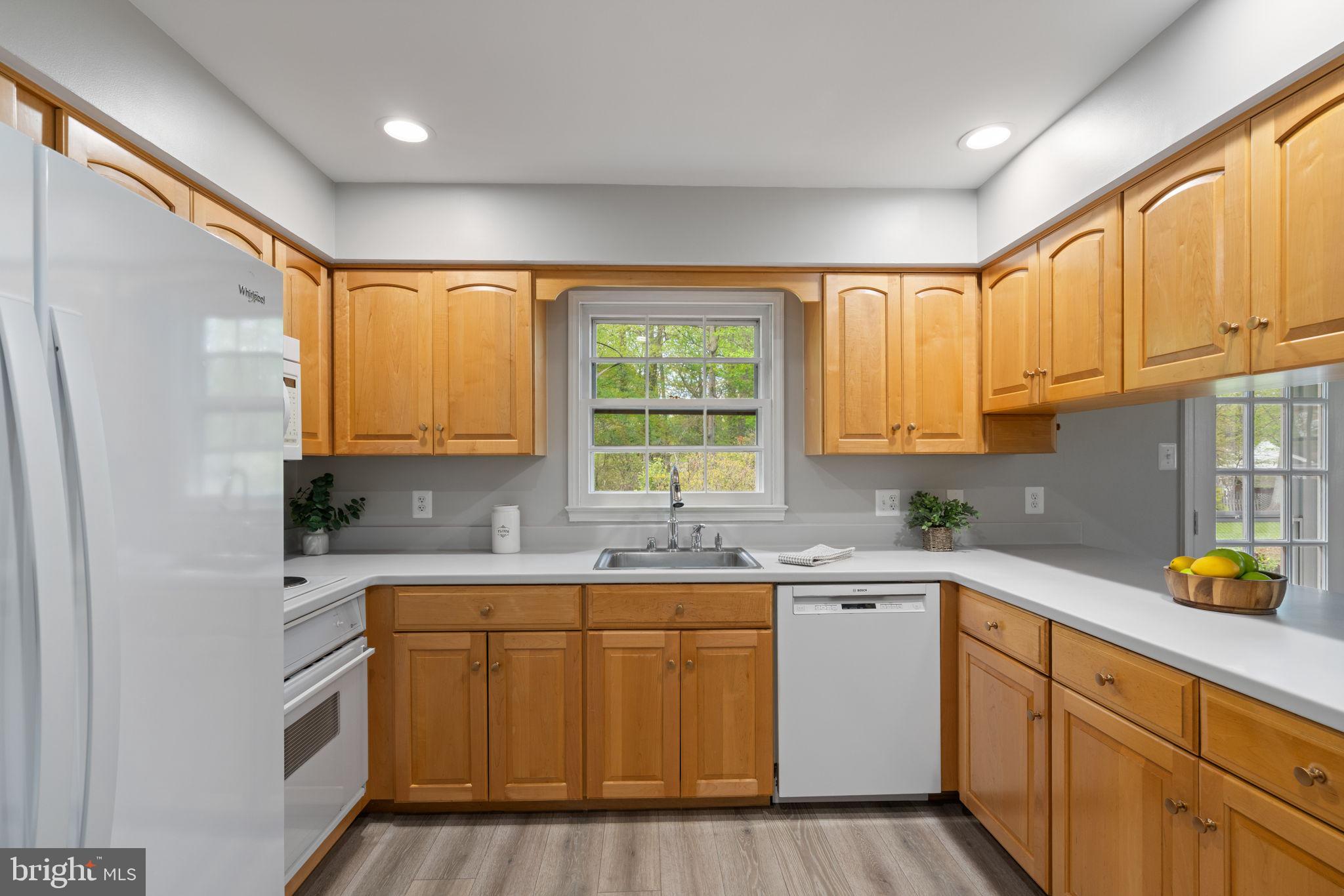 8328 Carrleigh Parkway Springfield, VA 22152 - Photo 12 of 58 a kitchen with a sink a window cabinets and stainless steel appliances