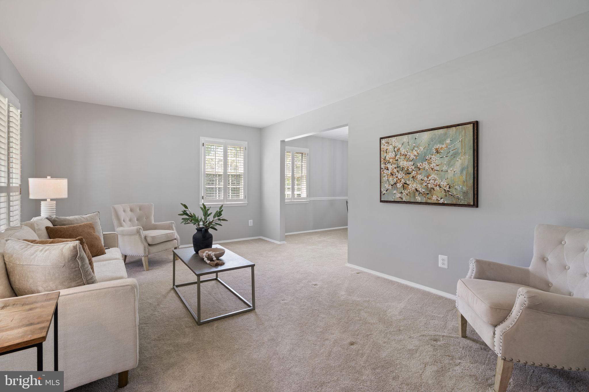 8328 Carrleigh Parkway Springfield, VA 22152 - Photo 17 of 58 a living room with furniture and a potted plant