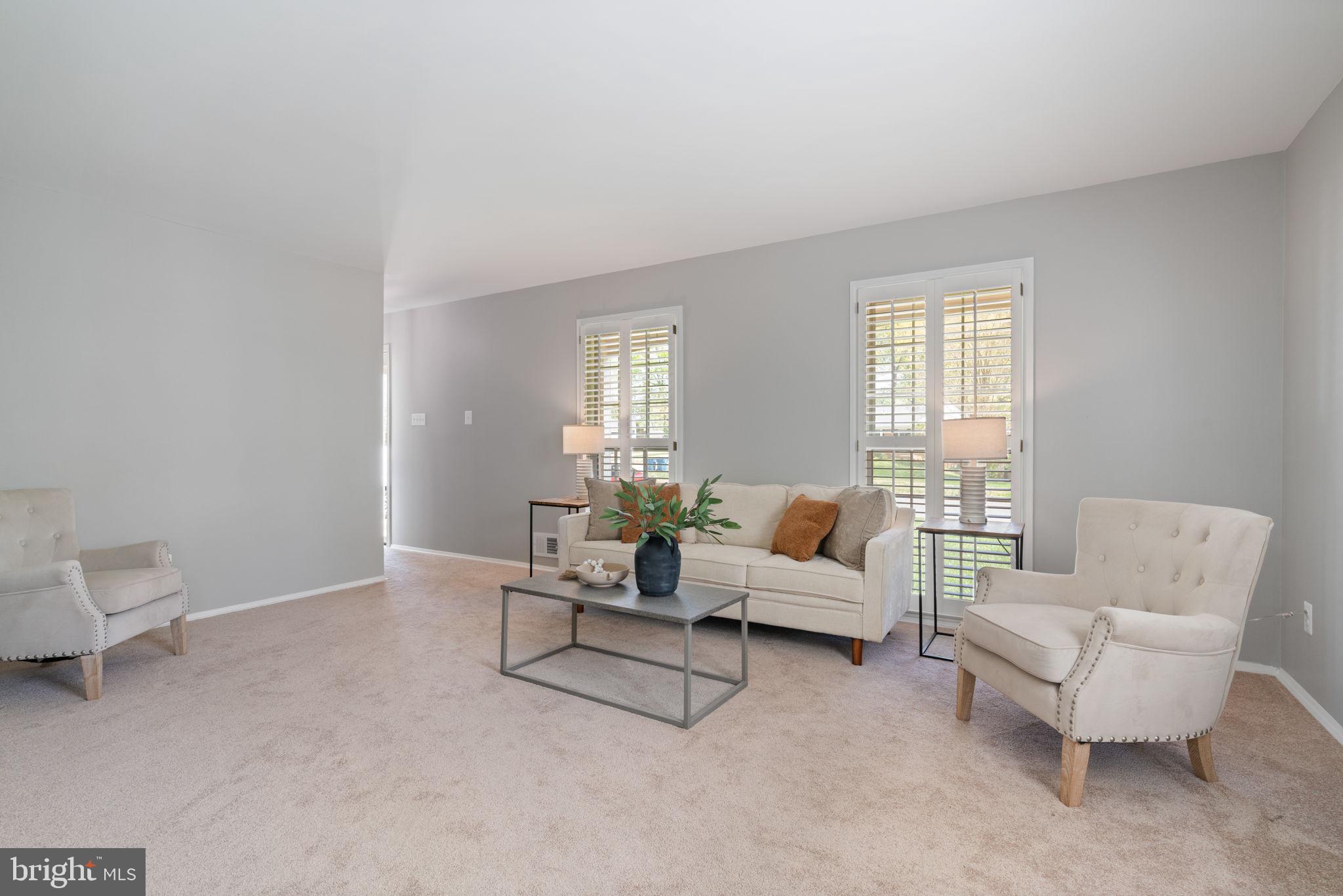 8328 Carrleigh Parkway Springfield, VA 22152 - Photo 18 of 58 a living room with furniture and a window