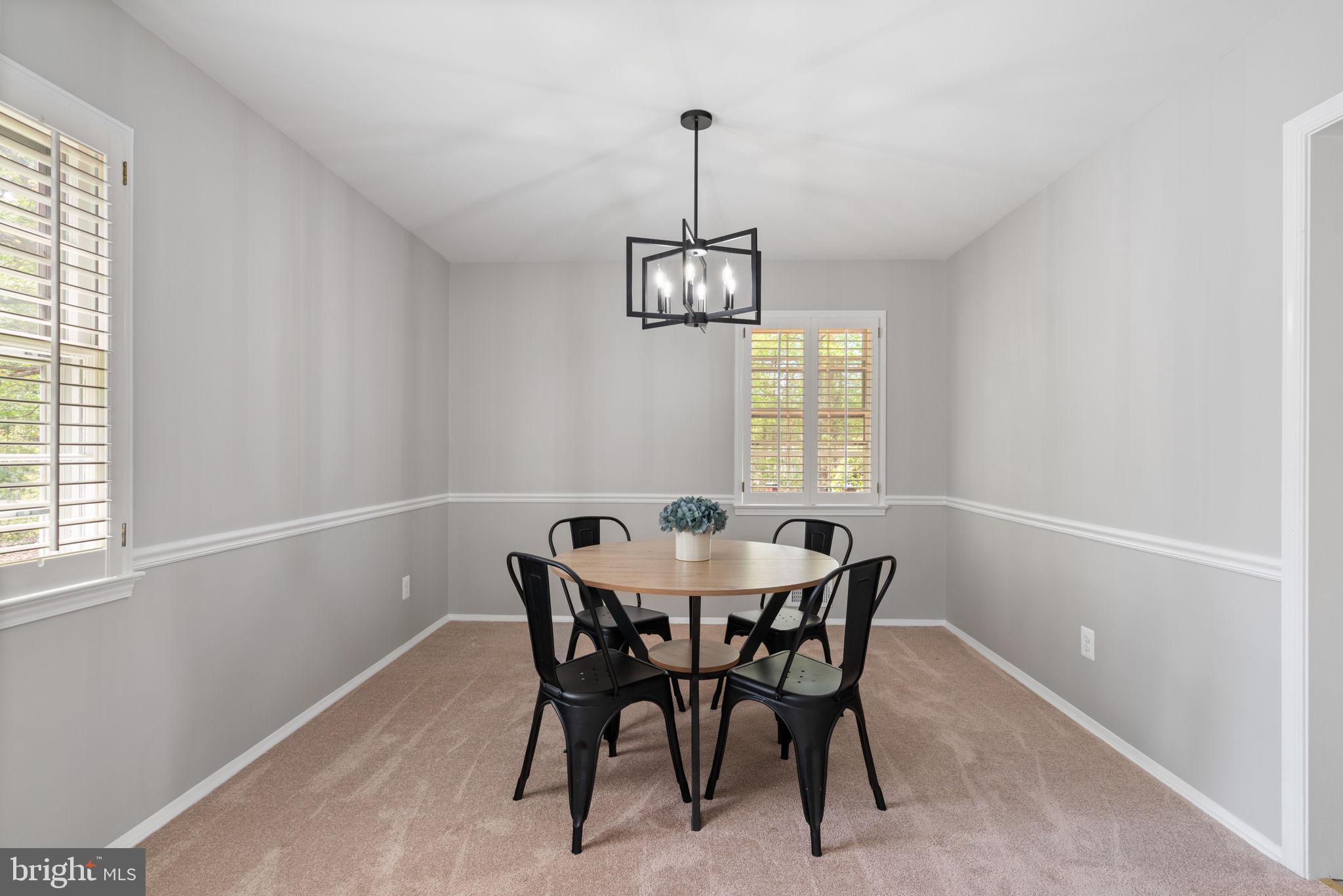 8328 Carrleigh Parkway Springfield, VA 22152 - Photo 20 of 58 a view of a dining room with furniture window and chandelier