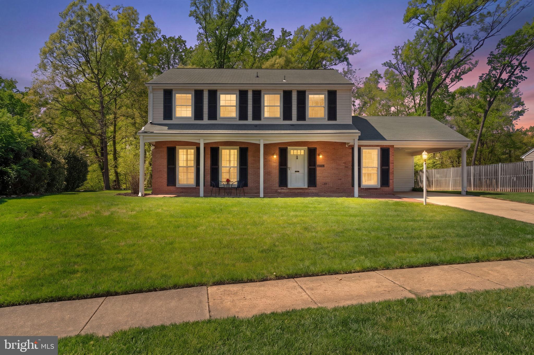 8328 Carrleigh Parkway Springfield, VA 22152 - Photo 2 of 58 a front view of a house with a garden