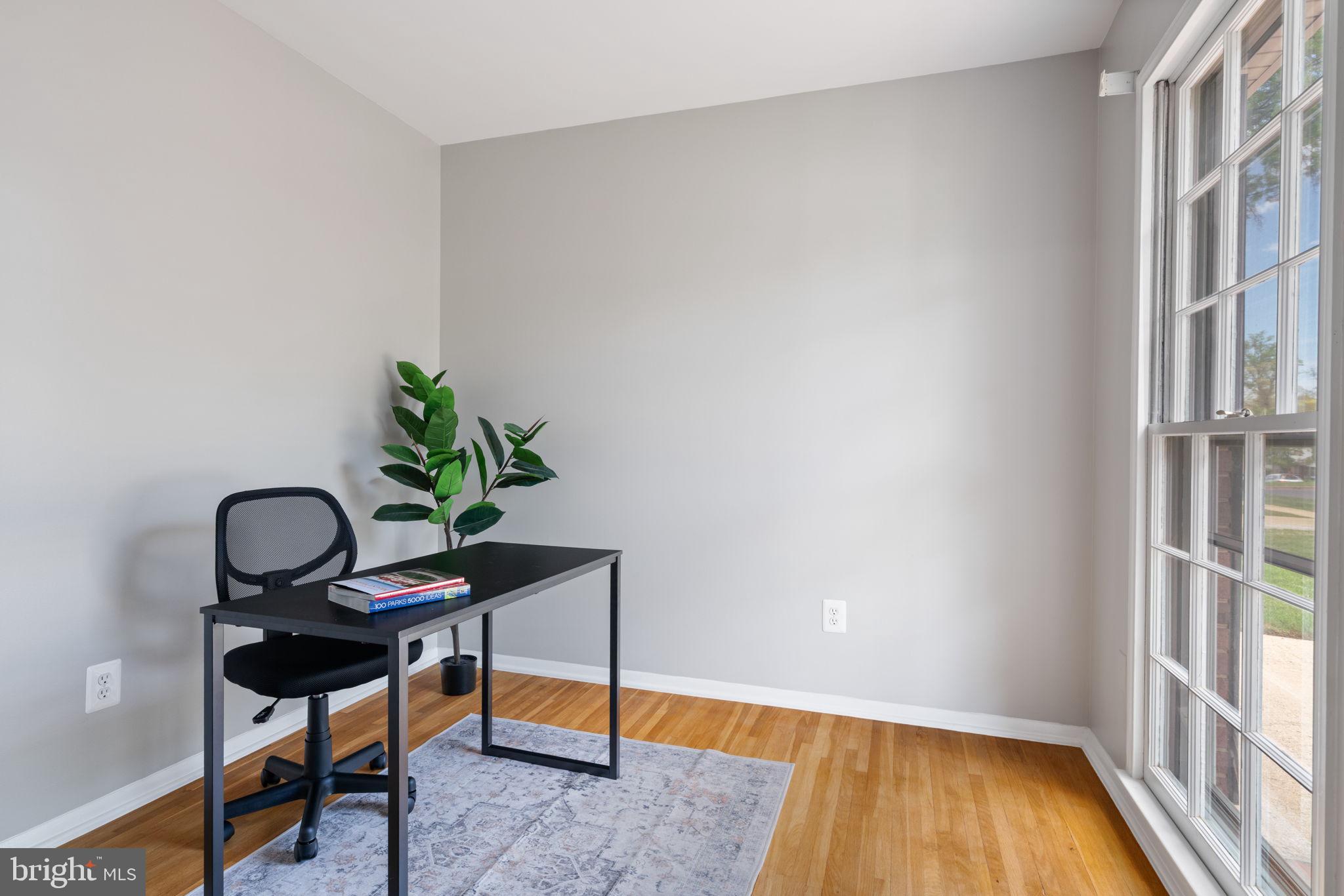 8328 Carrleigh Parkway Springfield, VA 22152 - Photo 22 of 58 a view of a workspace room with wooden floor and a window