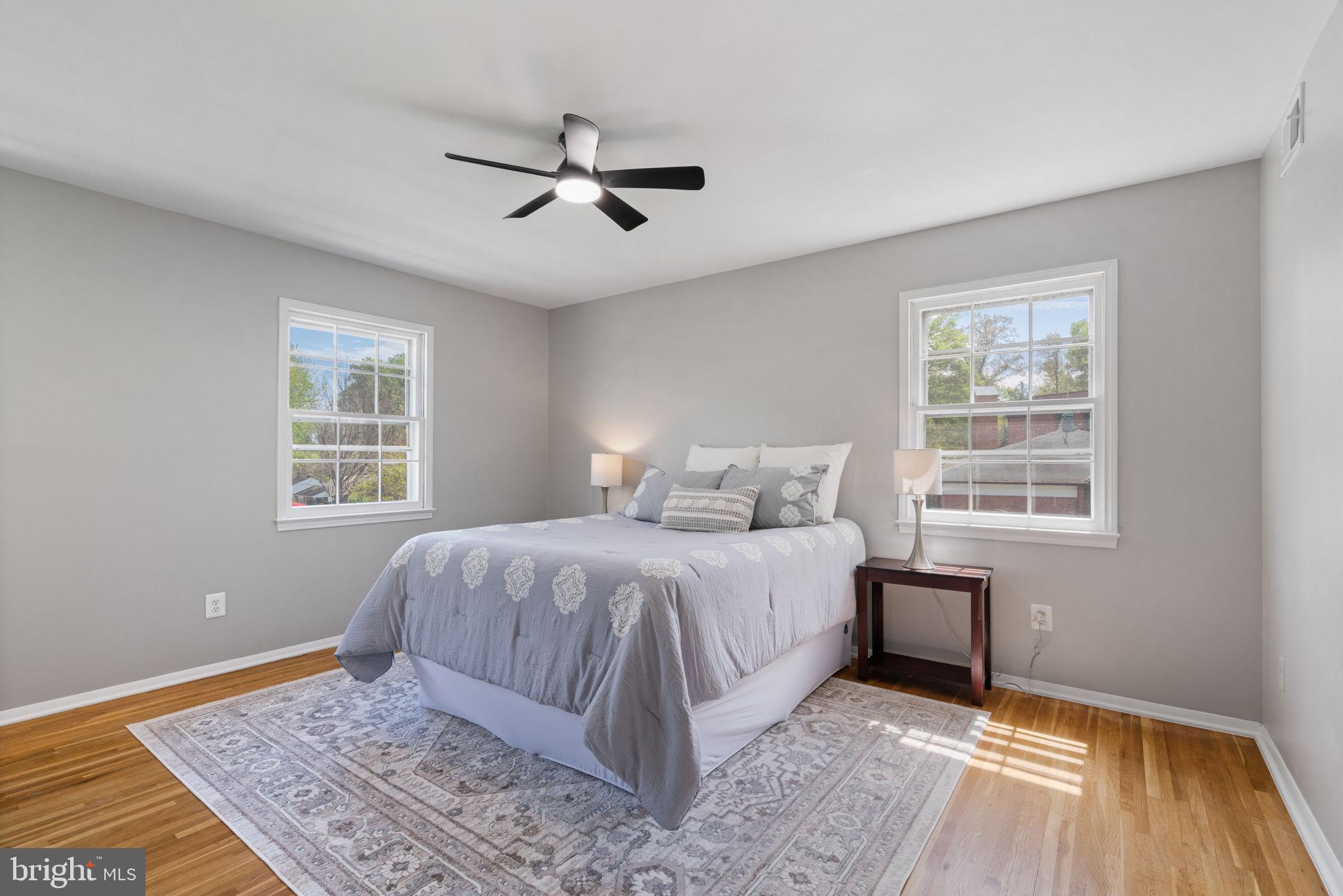 8328 Carrleigh Parkway Springfield, VA 22152 - Photo 23 of 58 a bed sitting in a bedroom next to a window