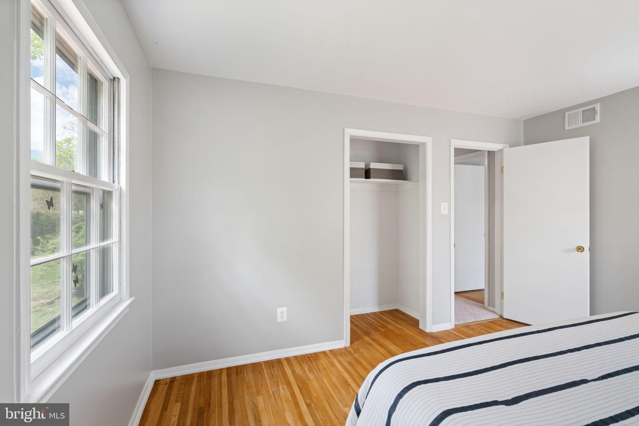 8328 Carrleigh Parkway Springfield, VA 22152 - Photo 29 of 58 a bedroom with a bed and a window