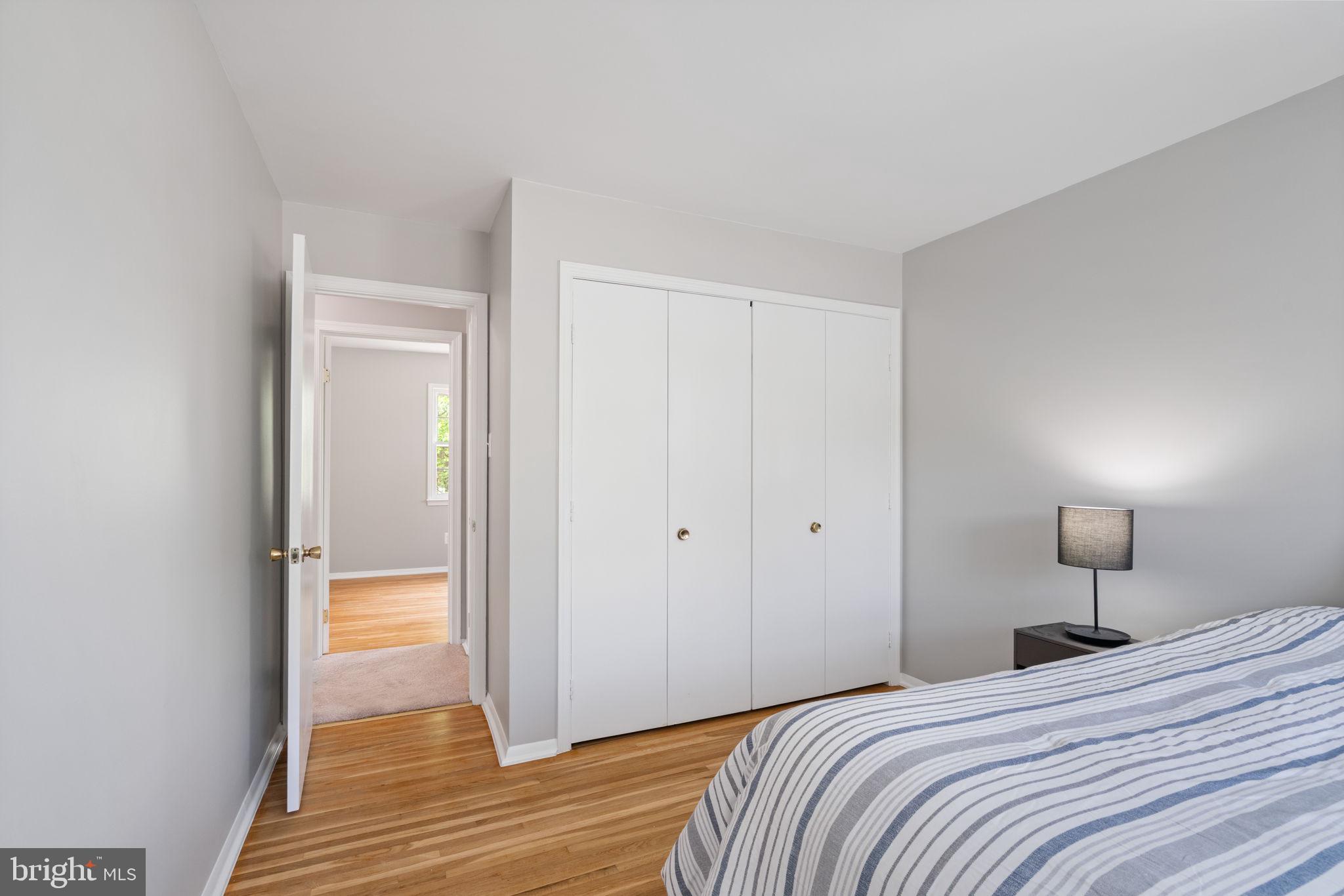8328 Carrleigh Parkway Springfield, VA 22152 - Photo 31 of 58 a bedroom with a bed and a mirror