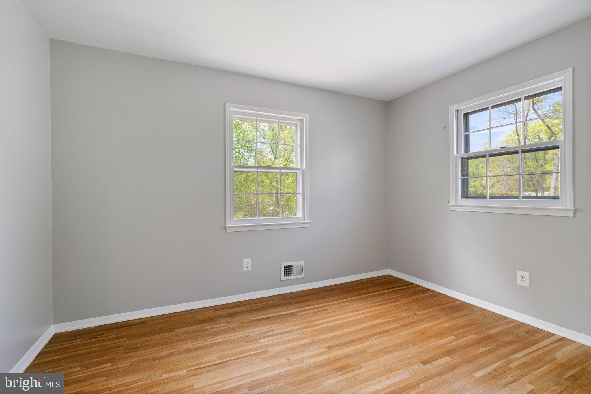 8328 Carrleigh Parkway Springfield, VA 22152 - Photo 32 of 58 a view of an empty room with wooden floor and a window