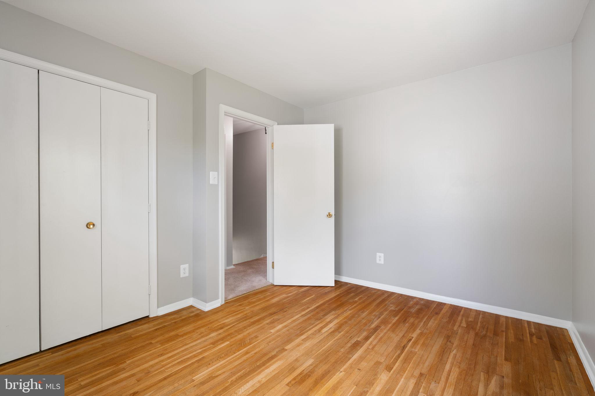 8328 Carrleigh Parkway Springfield, VA 22152 - Photo 33 of 58 a view of empty room with wooden floor