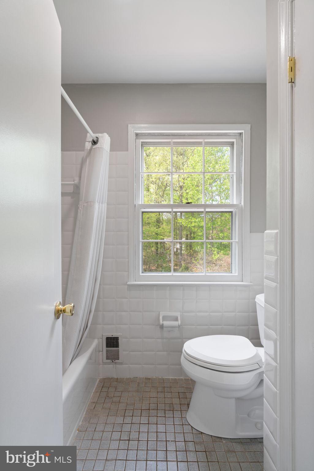 8328 Carrleigh Parkway Springfield, VA 22152 - Photo 35 of 58 a bathroom with a toilet and a shower