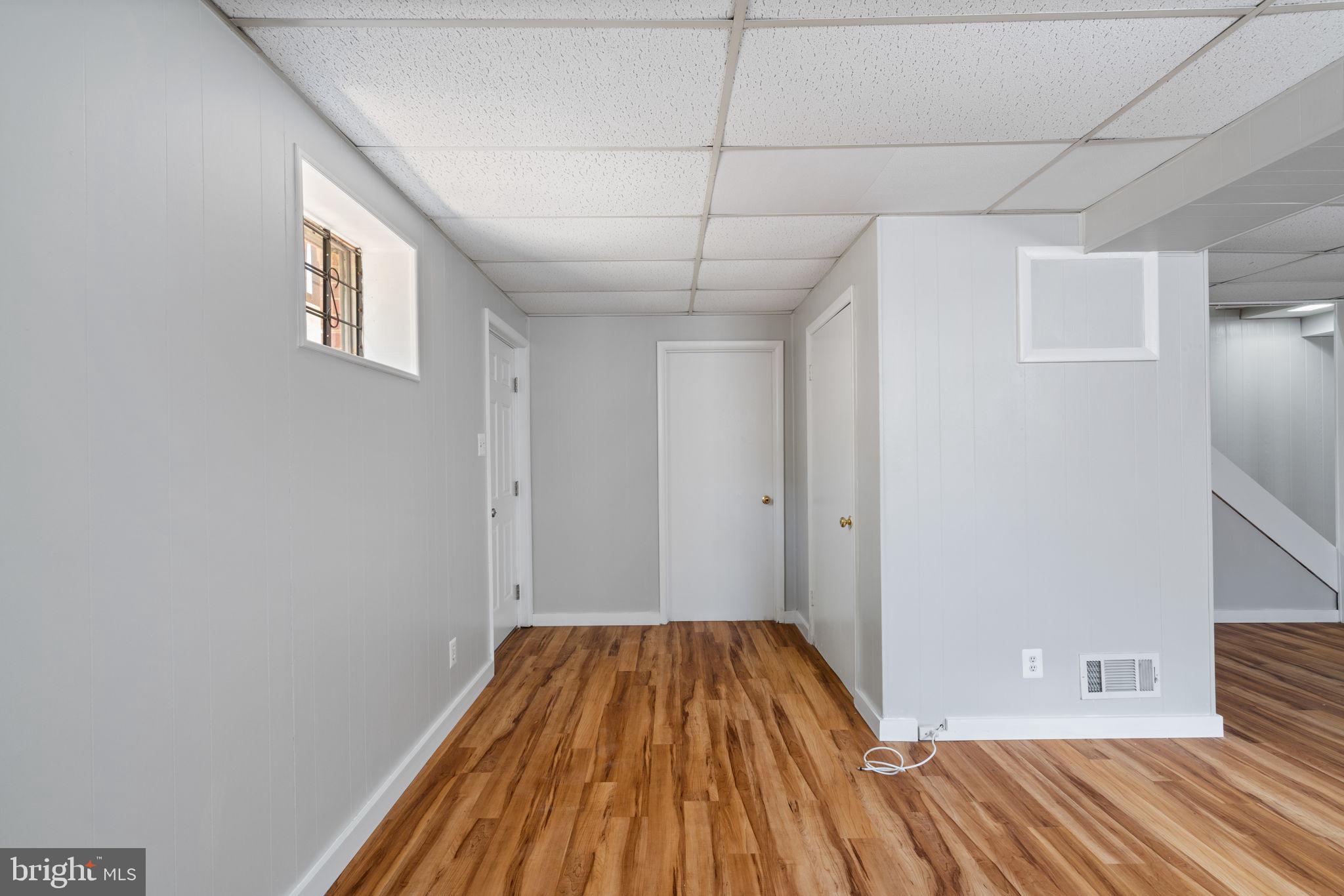 8328 Carrleigh Parkway Springfield, VA 22152 - Photo 38 of 58 a view of a room with wooden floor and staircase