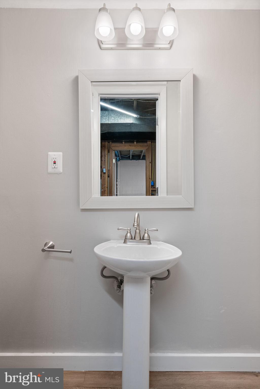 8328 Carrleigh Parkway Springfield, VA 22152 - Photo 43 of 58 a bathroom with a sink and a mirror