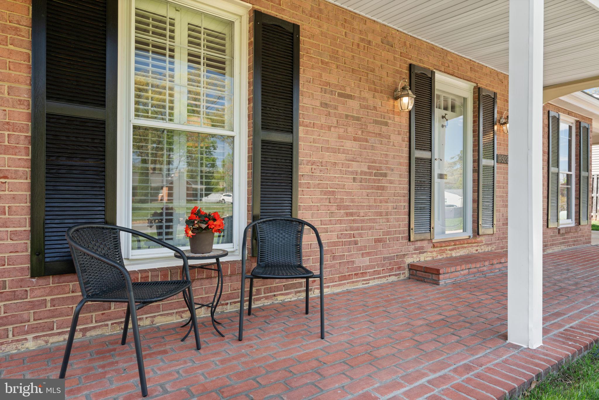 8328 Carrleigh Parkway Springfield, VA 22152 - Photo 45 of 58 a porch area with table and chairs