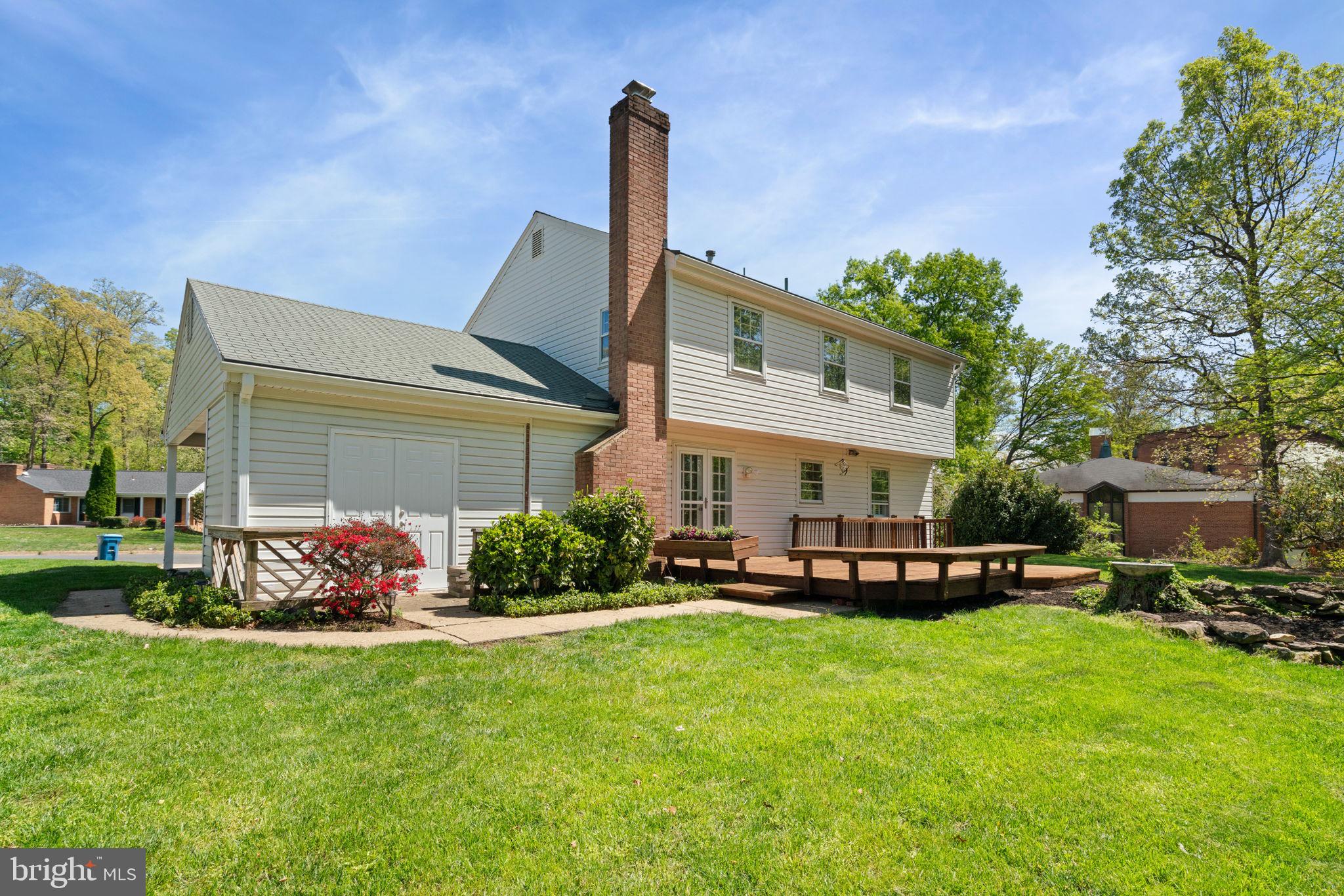 8328 Carrleigh Parkway Springfield, VA 22152 - Photo 50 of 58 a front view of a house with a garden and fountain