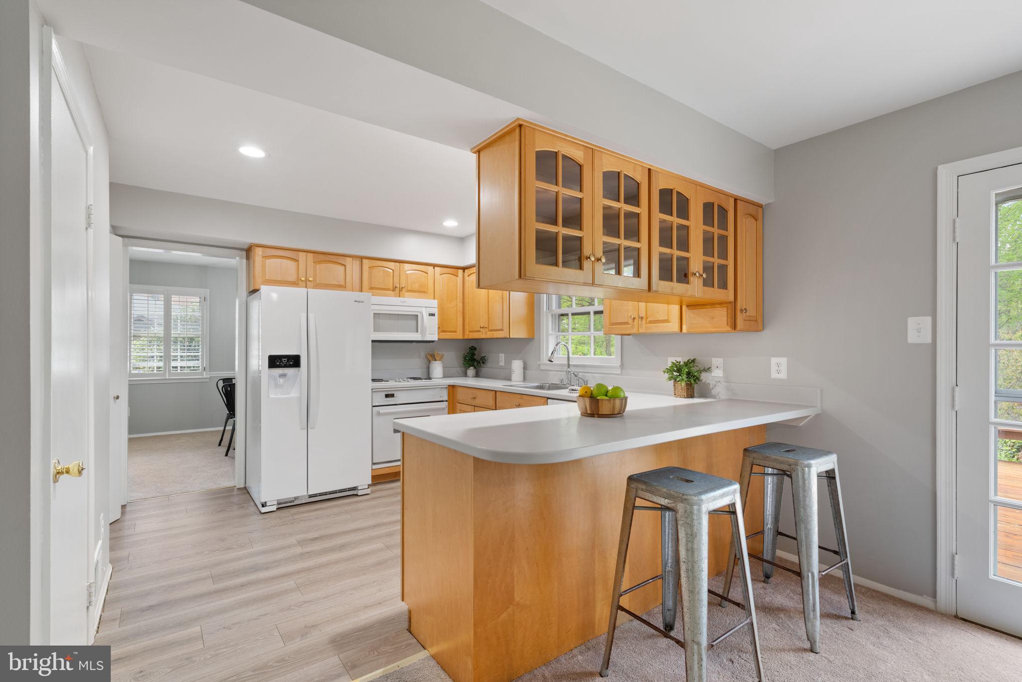 8328 Carrleigh Parkway Springfield, VA 22152 - Photo 10 of 58 a kitchen with stainless steel appliances a sink and a refrigerator