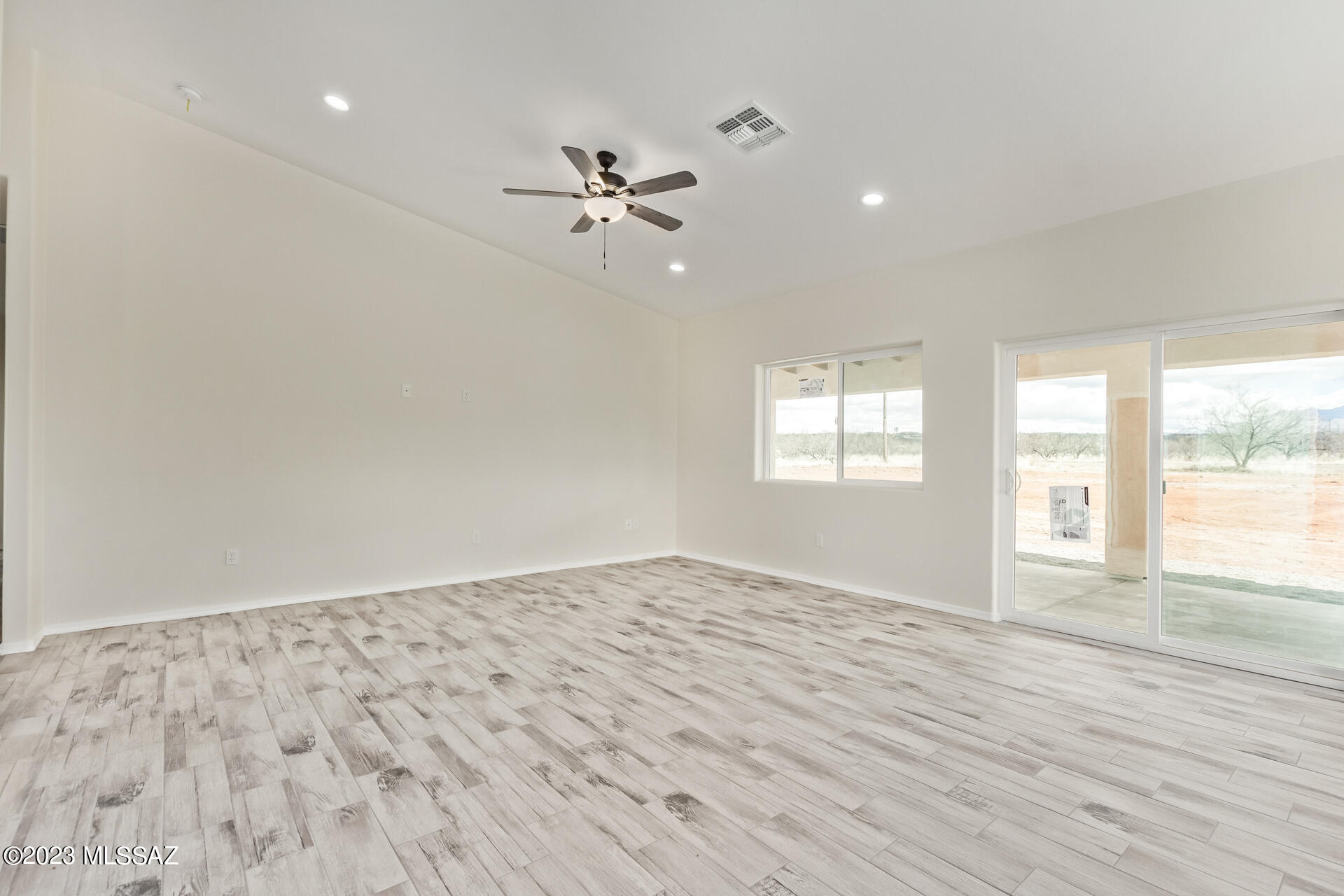 1795 Escobedo Court Rio Rico, AZ 85648 - Photo 5 of 30 a view of empty room with wooden floor and fan