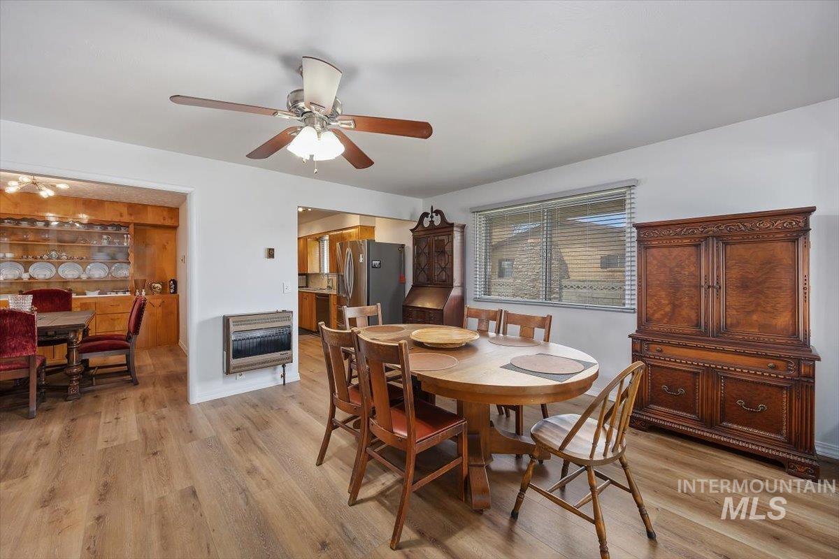 2012 21st Street Heyburn, ID 83336 - Photo 14 of 38 Dining space with heating unit, light wood finished floors, and ceiling fan
