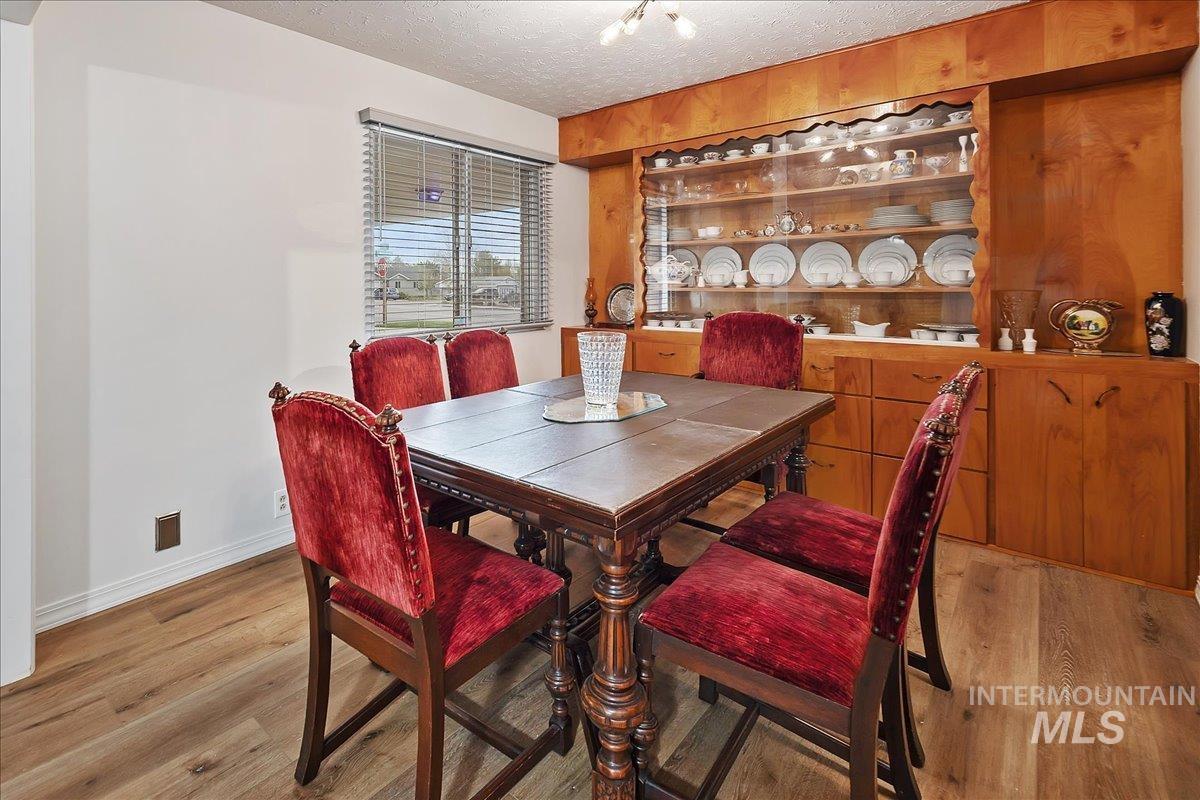 2012 21st Street Heyburn, ID 83336 - Photo 15 of 38 Dining room featuring light wood-type flooring and a textured ceiling