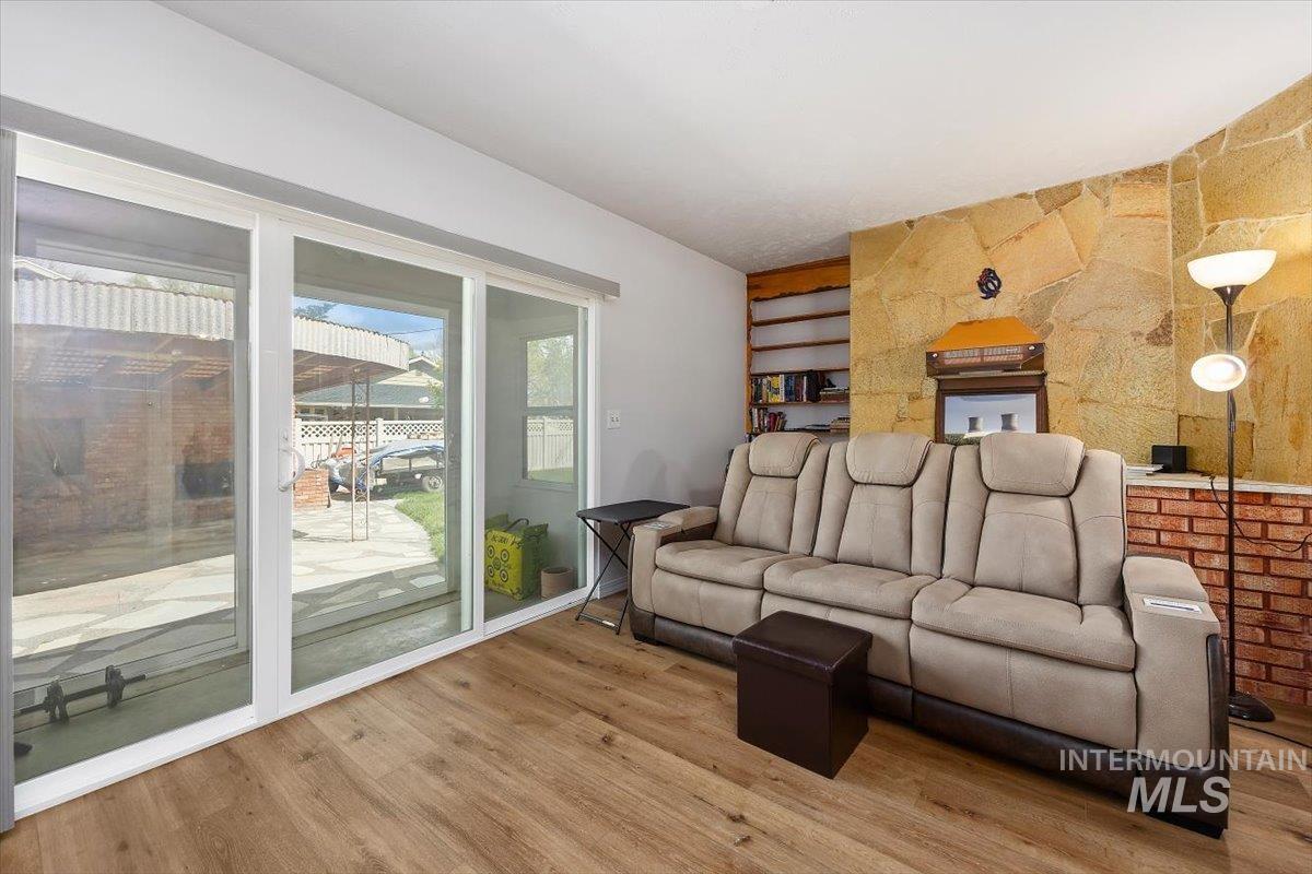 2012 21st Street Heyburn, ID 83336 - Photo 23 of 38 Living area featuring an accent wall and wood finished floors