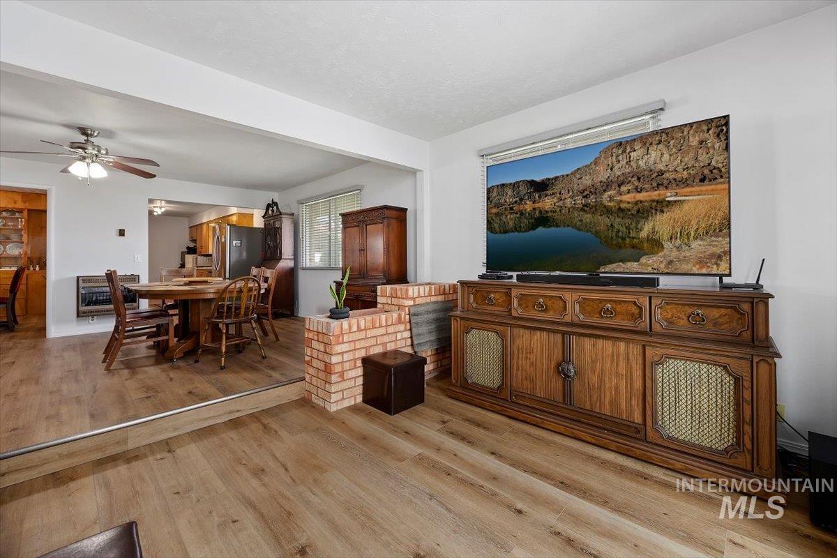 2012 21st Street Heyburn, ID 83336 - Photo 24 of 38 Living room featuring ceiling fan, light wood-style flooring, and heating unit