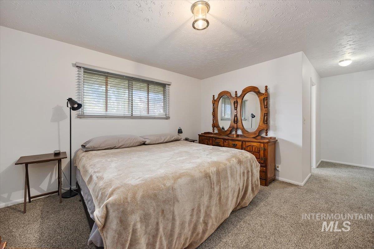 2012 21st Street Heyburn, ID 83336 - Photo 25 of 38 Carpeted bedroom featuring a textured ceiling and baseboards
