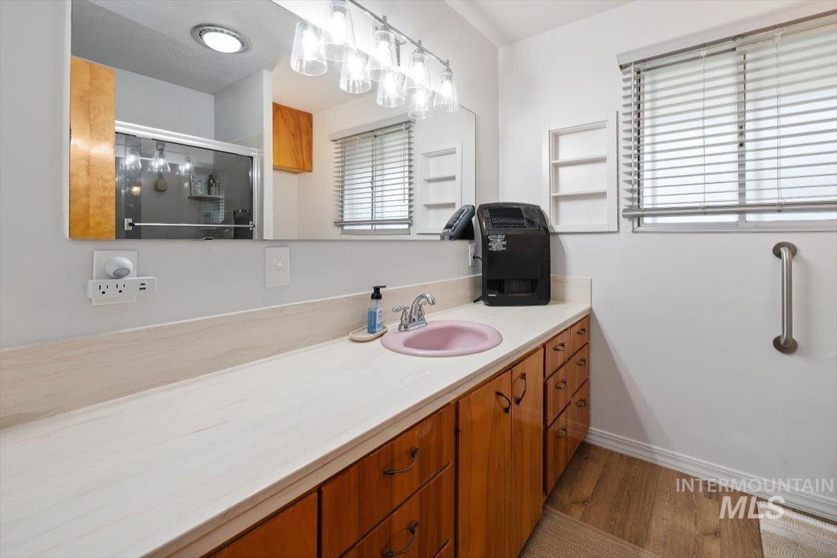 2012 21st Street Heyburn, ID 83336 - Photo 26 of 38 Bathroom with vanity, light wood-type flooring, and a shower stall