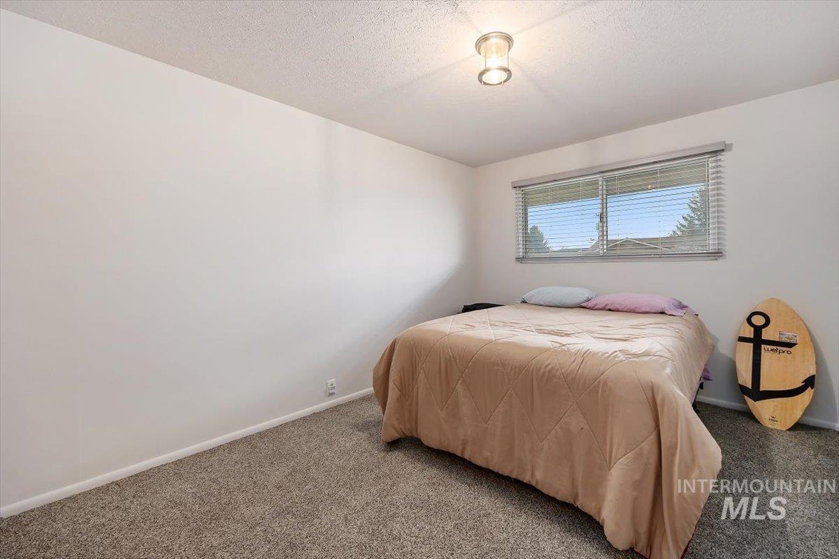 2012 21st Street Heyburn, ID 83336 - Photo 27 of 38 Bedroom with a textured ceiling and carpet