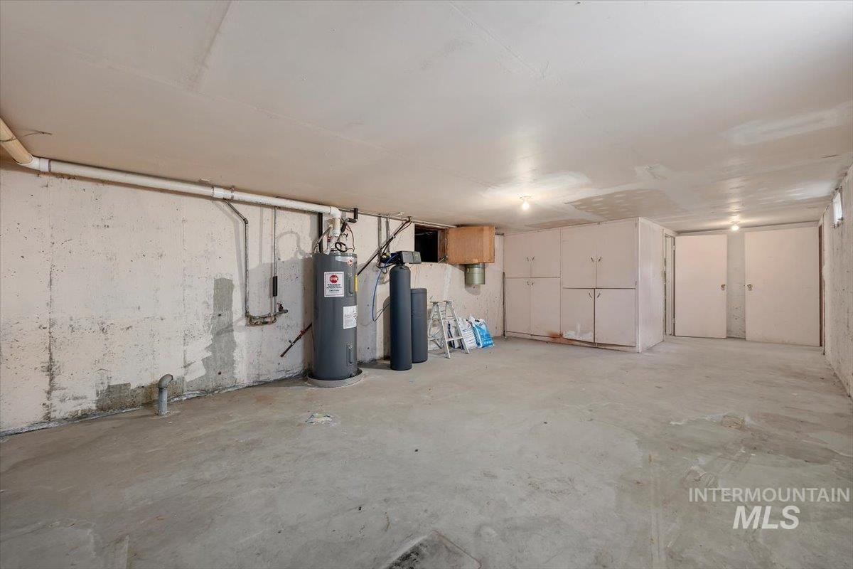 2012 21st Street Heyburn, ID 83336 - Photo 32 of 38 Unfinished basement with electric water heater and a water softener system