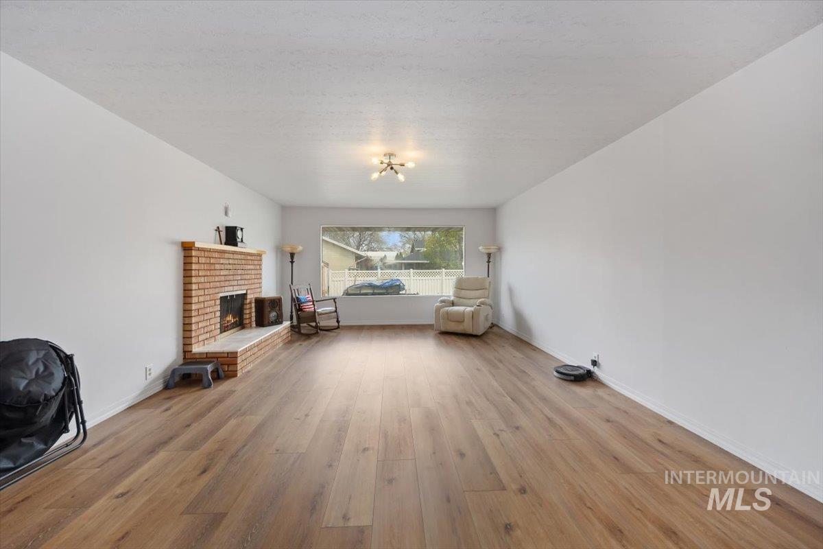 2012 21st Street Heyburn, ID 83336 - Photo 7 of 38 Bedroom with light wood-style flooring and a brick fireplace