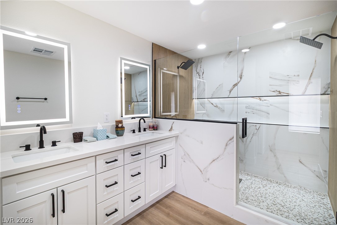 1891 Brian Road Pahrump, NV 89048 - Photo 16 of 50 Bathroom with visible vents, a marble finish shower, and a sink
