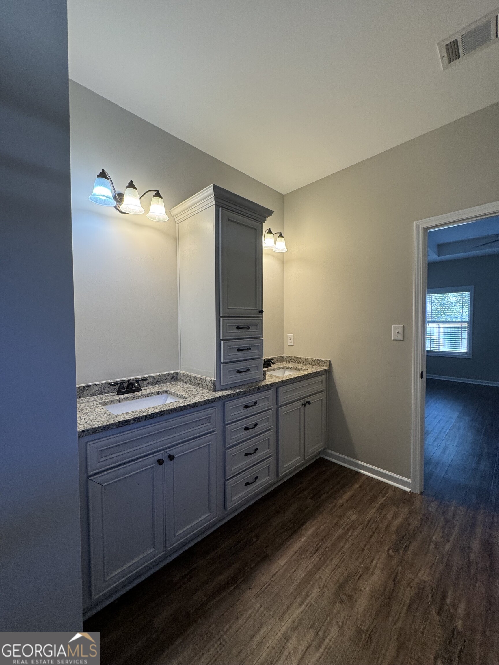 205 Havant Way Perry, GA 31069 - Photo 2 of 9 a spacious bathroom with a granite countertop sink and mirror