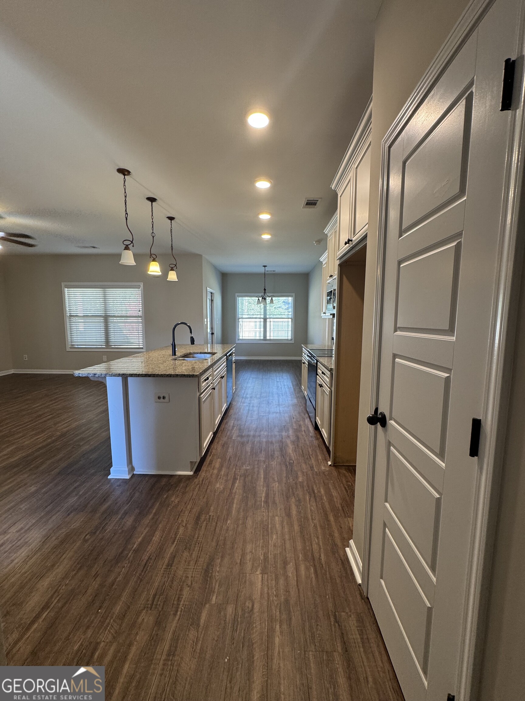205 Havant Way Perry, GA 31069 - Photo 3 of 9 a kitchen with kitchen island wooden floors appliances and wooden floor