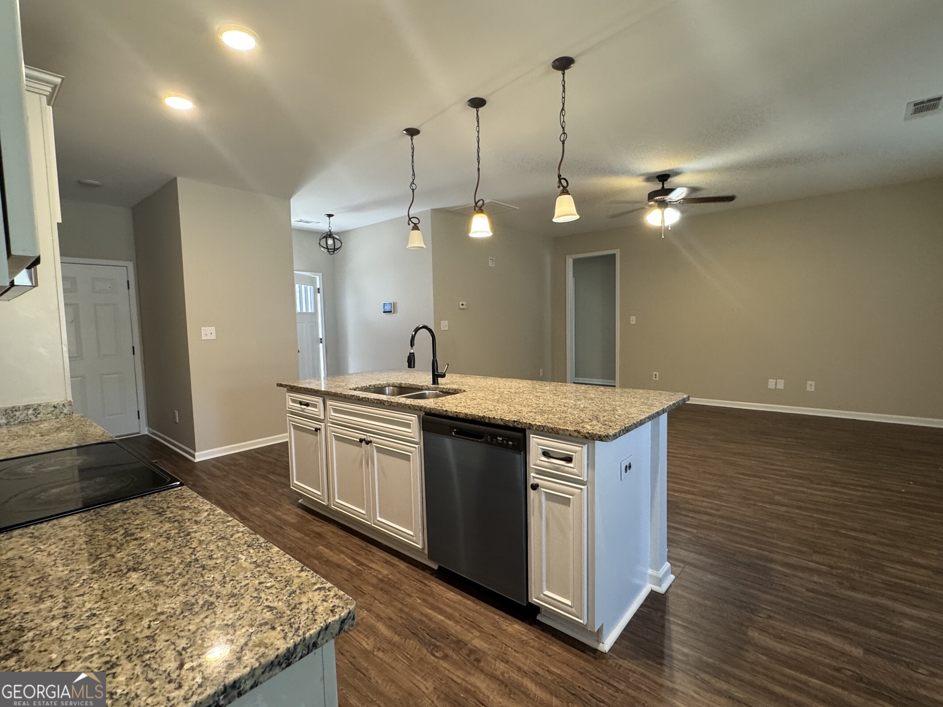205 Havant Way Perry, GA 31069 - Photo 5 of 9 a kitchen with a stove and wooden floor