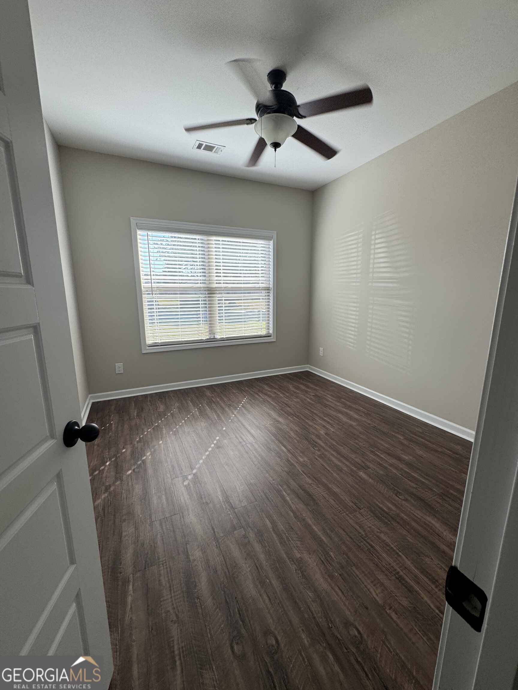 205 Havant Way Perry, GA 31069 - Photo 7 of 9 wooden floor in an empty room with a window