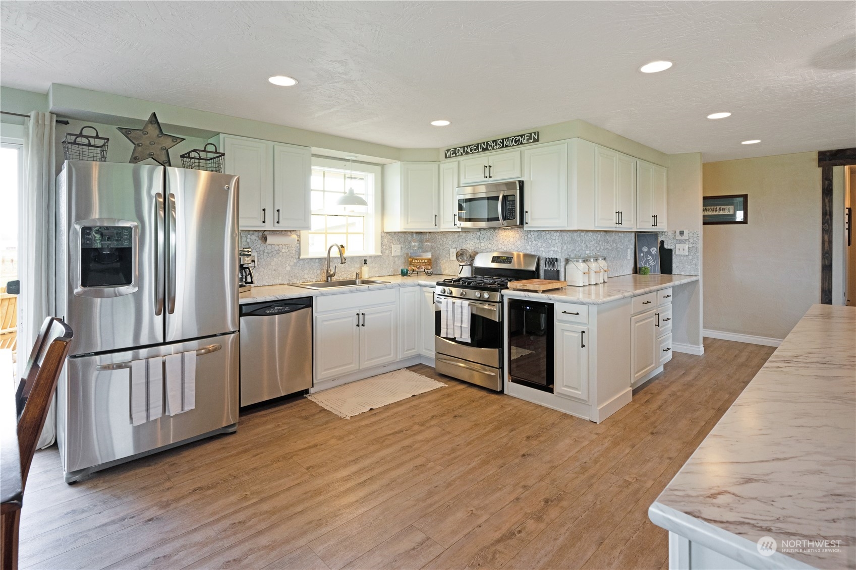 132 Swegle Road Walla Walla, WA 99362 - Photo 9 of 40 a kitchen with stainless steel appliances granite countertop a stove top oven a sink and a refrigerator