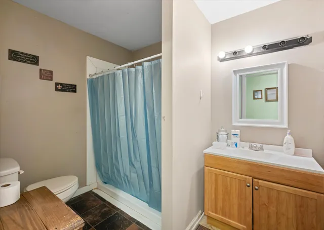 a view of a hallway with bathroom and utility room