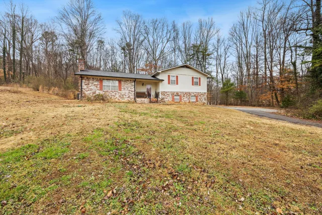 a view of a house with a yard and trees