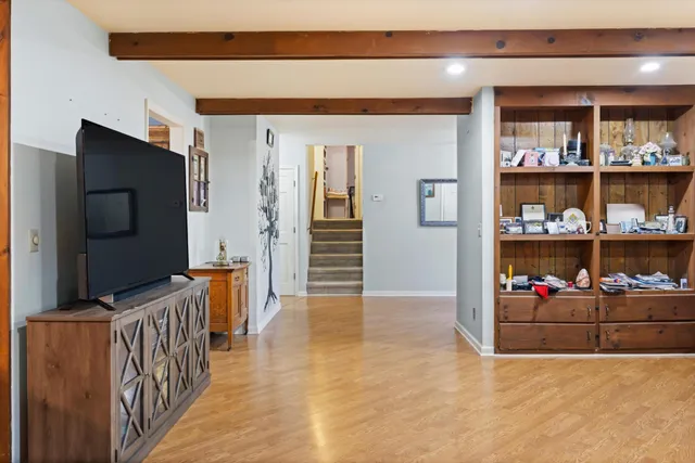 a living room with furniture a flat screen tv and a fireplace