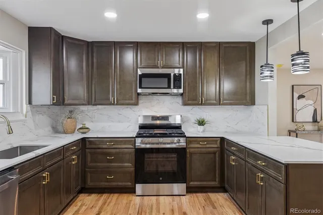 a kitchen with sink a microwave and cabinets
