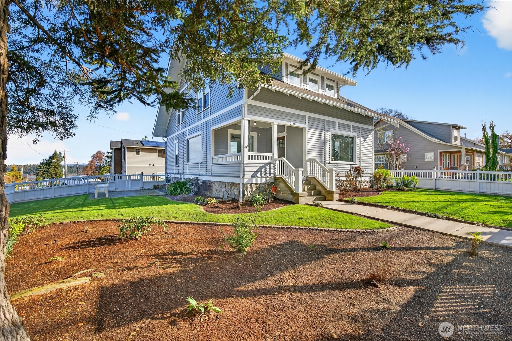 2120 12th Street Anacortes, WA 98221 - Photo 2 of 40 a front view of a house with a yard and potted plants