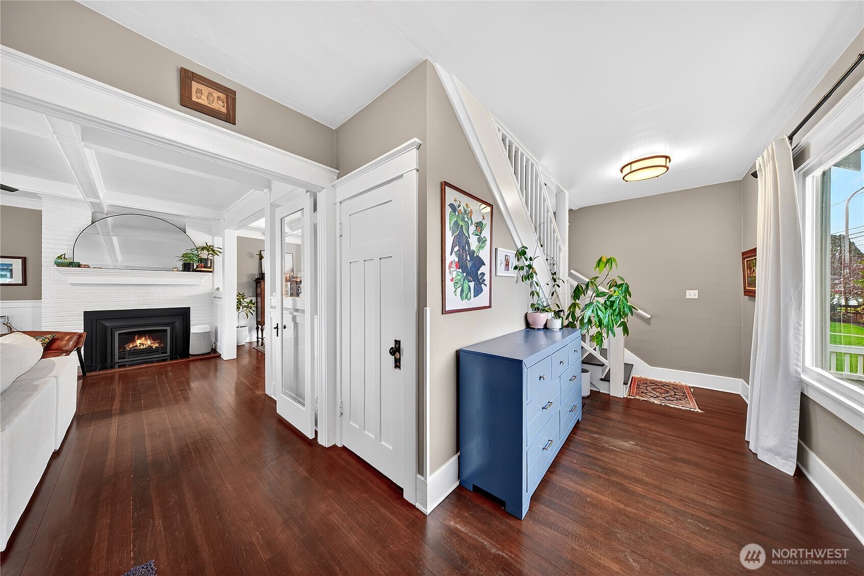 2120 12th Street Anacortes, WA 98221 - Photo 23 of 40 a view of a hallway with wooden floor and a fireplace