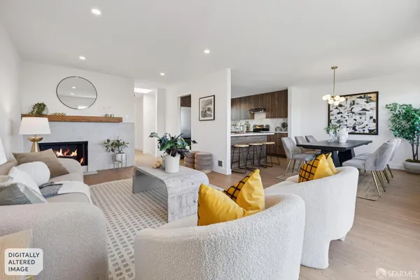 a living room with furniture kitchen view and a fireplace