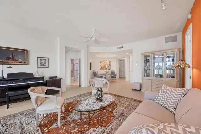 a spacious bedroom with a large bed and a chandelier