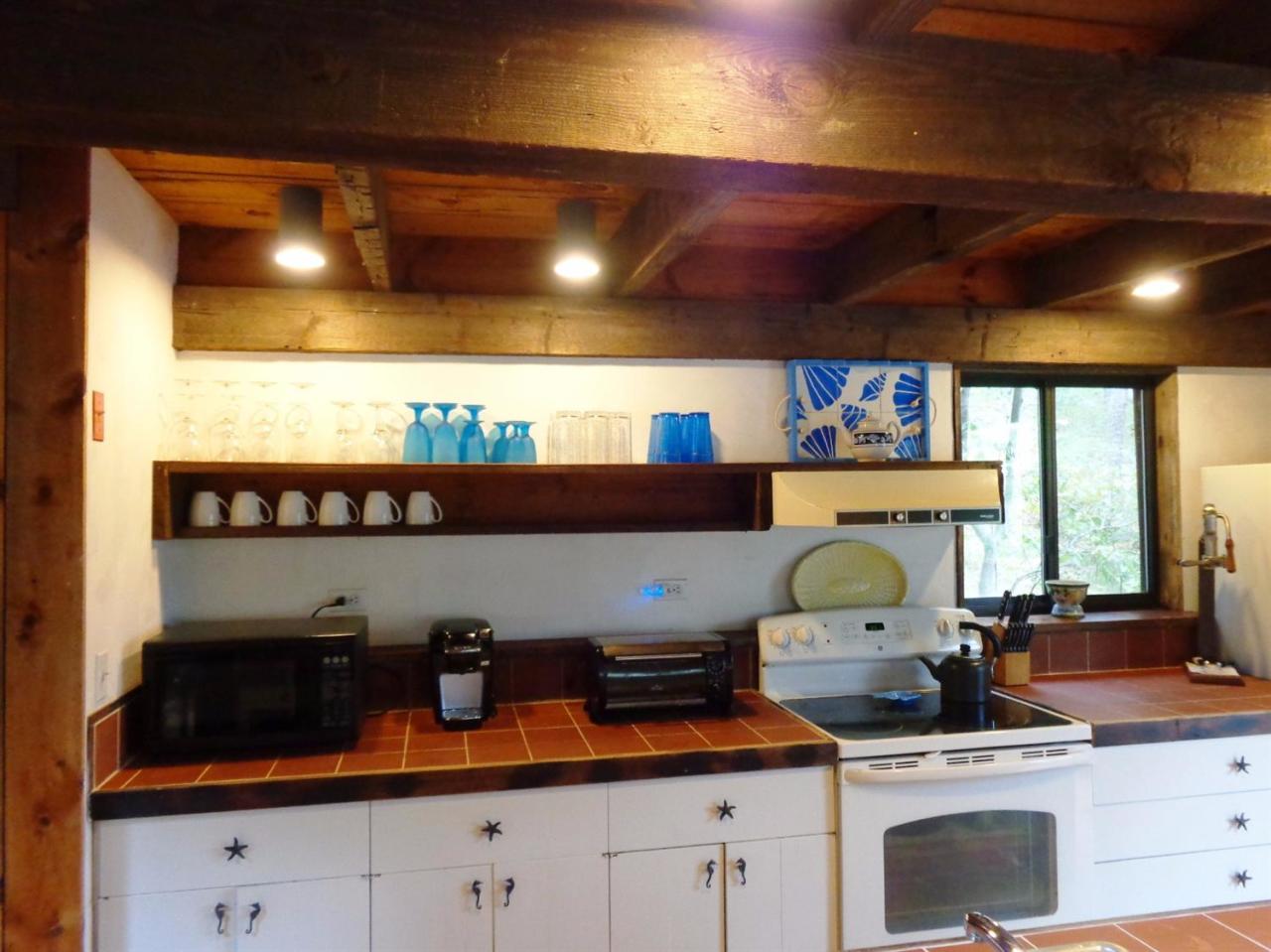200 Gull Pond Road Wellfleet, MA 02667 - Photo 12 of 35 a kitchen with a stove and cabinets