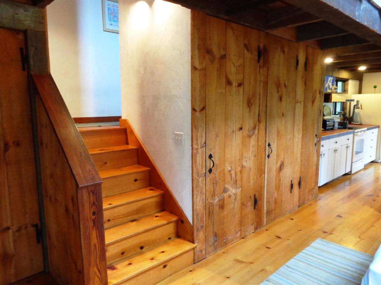200 Gull Pond Road Wellfleet, MA 02667 - Photo 17 of 35 a view of a hallway with wooden floor and staircase
